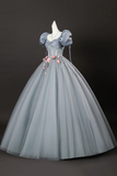 Vintage-style gray gown with floral details on a dark background