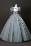 Gray ball gown on a mannequin against a black background