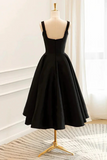 Black dress on a mannequin against a white wall