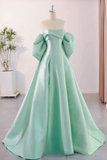Mint green evening gown on a mannequin against a light background