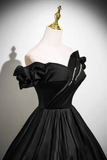 Black off-shoulder dress on a mannequin against a plain background