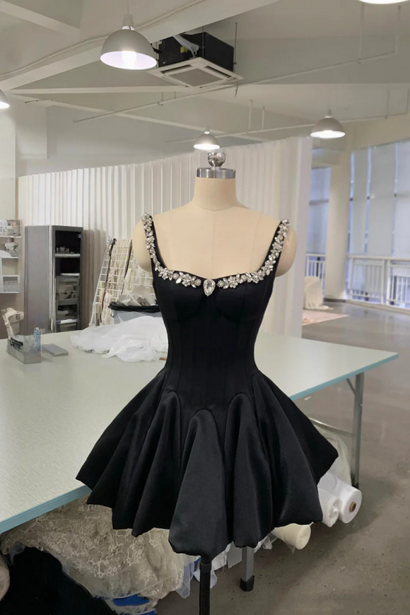 Black dress on a mannequin in a studio setting