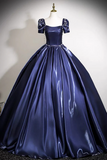 Navy blue ball gown on a mannequin against a neutral background
