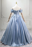 Light blue evening gown on a mannequin against a white wall.
