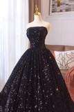 Black sequin dress on a mannequin against a neutral background