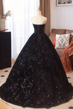 Black sequin gown on a mannequin in a room with curtains and furniture.