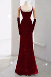 Red evening gown on a mannequin with gloves against a white background