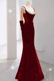 Red evening gown on a mannequin against a white background