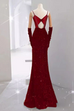 Red evening gown with cut-out back on a mannequin against a white background