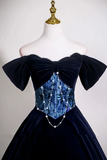 Navy blue velvet dress with intricate detailing on a mannequin against a white background