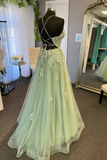 Green evening gown on a mannequin in a room with a mirror and decor.