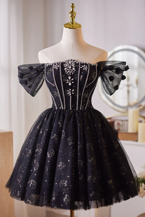 Black off-shoulder dress with floral embroidery on a mannequin against a neutral background.
