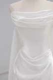 White off-shoulder dress on a mannequin against a gray background