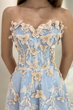 Light blue dress with butterfly lace details on a neutral background