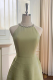 Light green dress on a mannequin against a neutral background