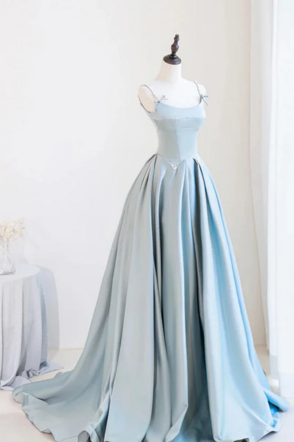 Light blue evening gown on a mannequin against a white background