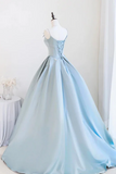 Light blue evening gown on a mannequin against a white background