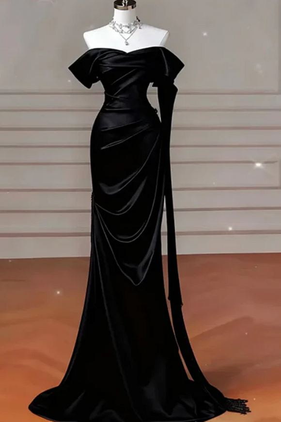 Black evening gown on a mannequin against a neutral background
