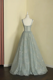 Light blue lace evening gown on a mannequin against a beige wall.