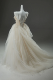 White wedding dress on a mannequin against a dark background