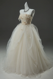 Beige wedding dress on a mannequin against a dark background