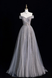 Gray evening gown on a mannequin against a black background