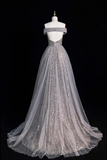 Elegant silver evening gown on a mannequin against a black background