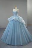 Light blue ball gown on a mannequin against a plain background