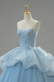 Light blue strapless gown on a mannequin against a gray background