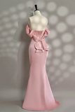 Pink evening gown on a mannequin against a neutral background