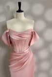 Pink evening gown on a mannequin against a neutral background