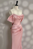 Pink evening gown on a mannequin against a blurred background