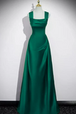 Green evening gown on a mannequin against a white background