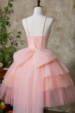 Pink tiered dress on a mannequin against a neutral background