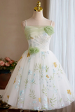 Green floral dress on a mannequin against a neutral background