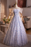 Elegant blue floral dress on a mannequin in a room setting
