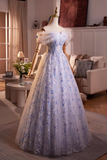 Elegant blue and white floral dress on a mannequin in a living room setting.