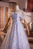 Elegant blue floral dress on a mannequin in a room setting