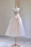 White tulle dress on a mannequin against a plain background