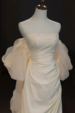 White dress on a mannequin against a black background