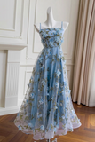 Light blue floral dress on a mannequin against a neutral background