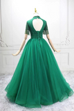 Green evening gown on a mannequin against a white background