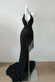 Black sequin evening gown with fringe on a mannequin against a white background