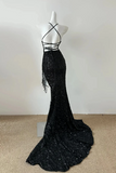 Black sequin evening gown on a mannequin against a plain background