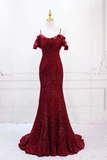 Red evening gown on a mannequin against a white background