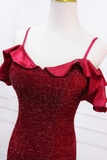 Red glittery dress with ruffled sleeves on a mannequin against a white background