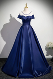 Navy blue evening gown on a mannequin against a plain background