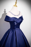 Navy blue satin dress on a mannequin with a plain background