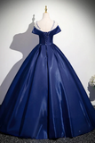 Navy blue ball gown on a mannequin against a plain background