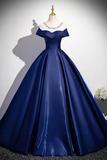 Navy blue evening gown with a white bodice on a mannequin against a gray background